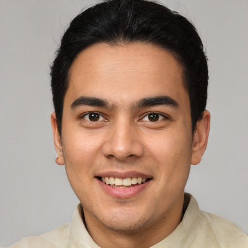 Joyful latino young-adult male with short  brown hair and brown eyes