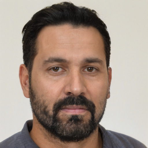 Neutral latino adult male with short  black hair and brown eyes