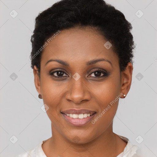 Joyful black young-adult female with short  black hair and brown eyes