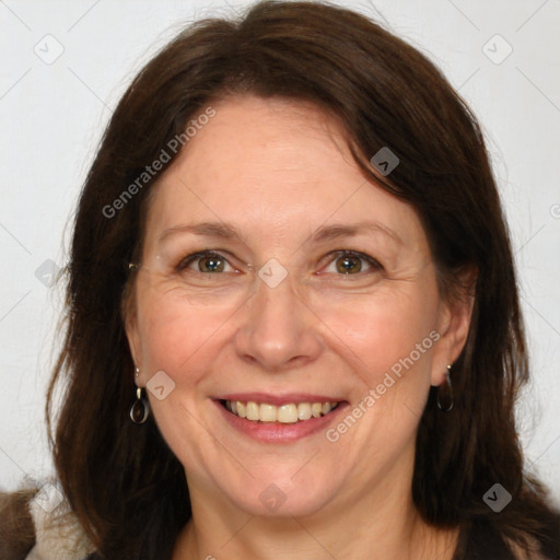 Joyful white adult female with long  brown hair and brown eyes