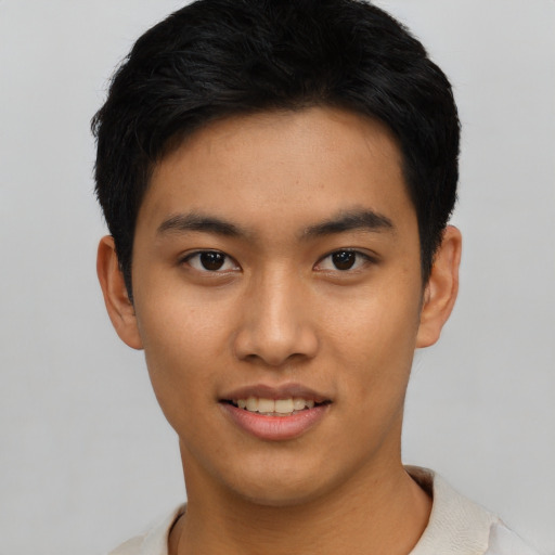 Joyful asian young-adult male with short  black hair and brown eyes