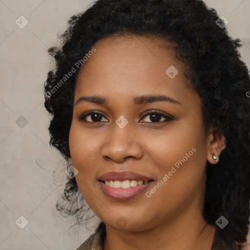 Joyful black young-adult female with long  black hair and brown eyes