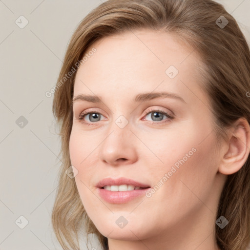 Joyful white young-adult female with long  brown hair and blue eyes