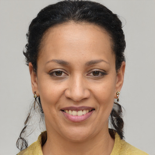 Joyful latino adult female with short  brown hair and brown eyes