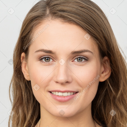 Joyful white young-adult female with long  brown hair and grey eyes