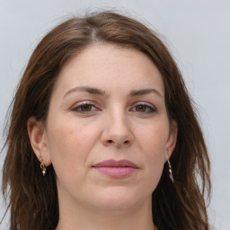 Joyful white adult female with long  brown hair and grey eyes