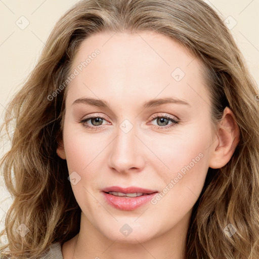 Joyful white young-adult female with long  brown hair and blue eyes