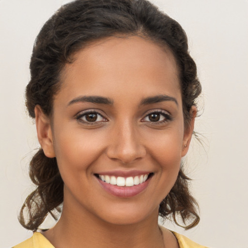 Joyful white young-adult female with long  brown hair and brown eyes