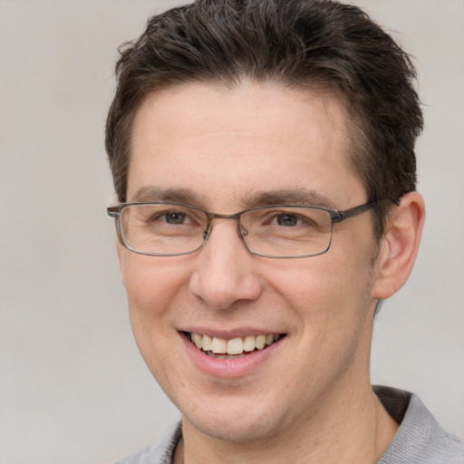 Joyful white adult male with short  brown hair and grey eyes