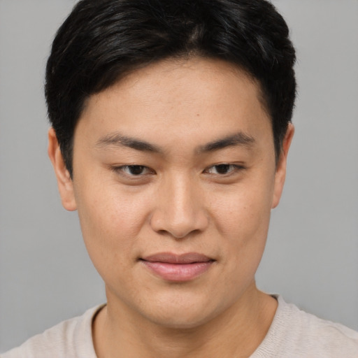 Joyful asian young-adult female with short  brown hair and brown eyes