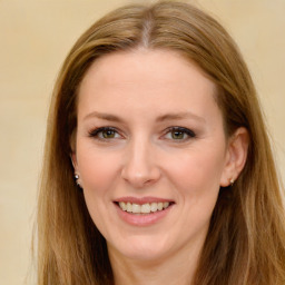 Joyful white young-adult female with long  brown hair and green eyes