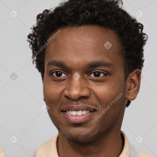 Joyful black young-adult male with short  brown hair and brown eyes