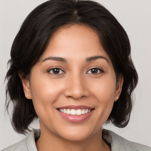 Joyful white young-adult female with medium  brown hair and brown eyes