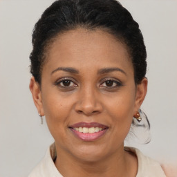 Joyful black young-adult female with short  brown hair and brown eyes