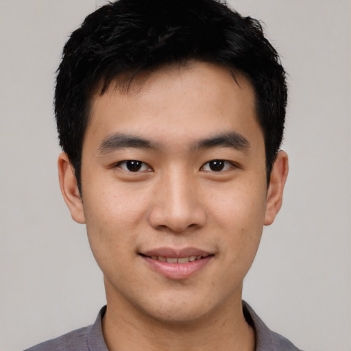 Joyful asian young-adult male with short  black hair and brown eyes