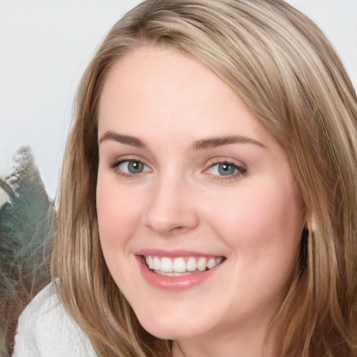 Joyful white young-adult female with long  brown hair and blue eyes