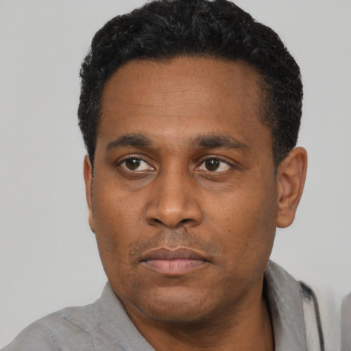 Neutral black adult male with short  black hair and brown eyes