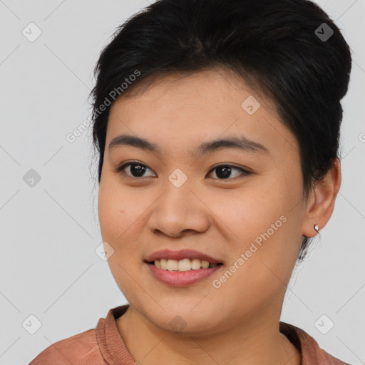 Joyful asian young-adult female with short  black hair and brown eyes