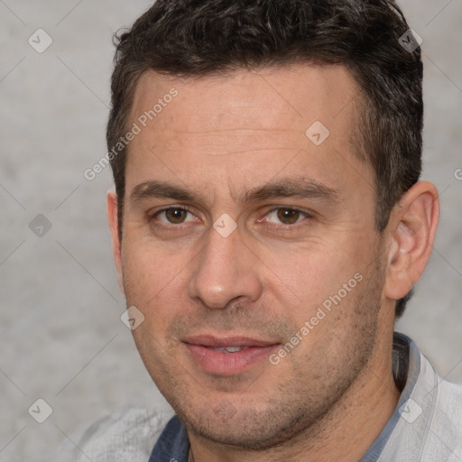 Joyful white adult male with short  brown hair and brown eyes