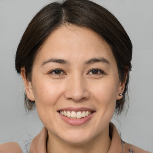 Joyful white young-adult female with medium  brown hair and brown eyes