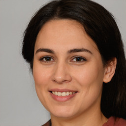 Joyful white adult female with long  brown hair and brown eyes