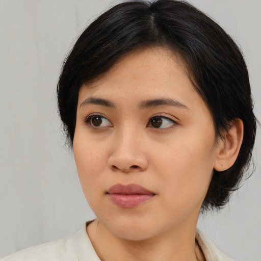 Joyful asian young-adult female with medium  black hair and brown eyes