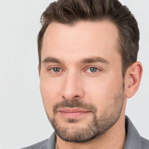 Joyful white adult male with short  brown hair and brown eyes