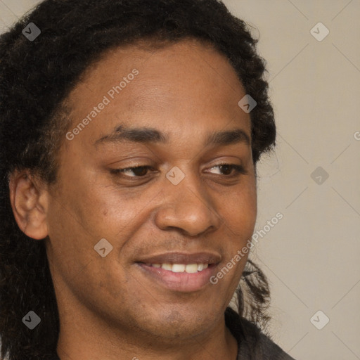 Joyful black young-adult male with short  brown hair and brown eyes