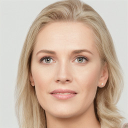 Joyful white young-adult female with long  brown hair and blue eyes