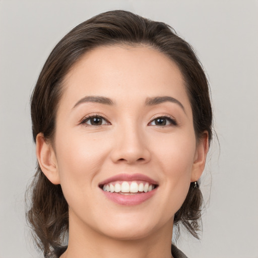 Joyful white young-adult female with medium  brown hair and brown eyes