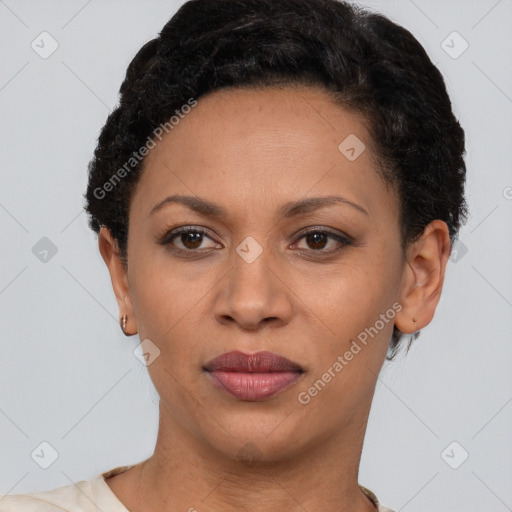 Joyful black young-adult female with short  black hair and brown eyes