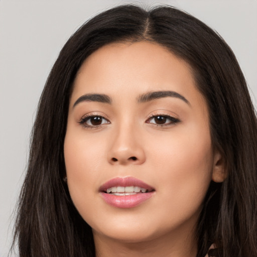 Joyful asian young-adult female with long  brown hair and brown eyes