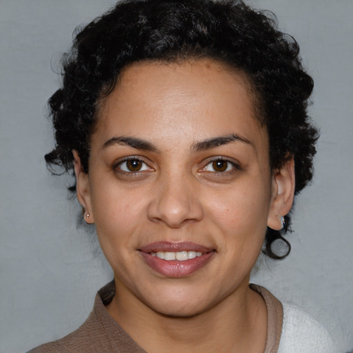 Joyful latino young-adult female with short  black hair and brown eyes