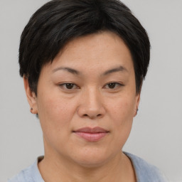 Joyful asian adult female with short  brown hair and brown eyes