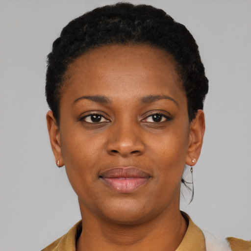 Joyful black young-adult female with short  black hair and brown eyes