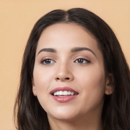 Joyful white young-adult female with long  black hair and brown eyes