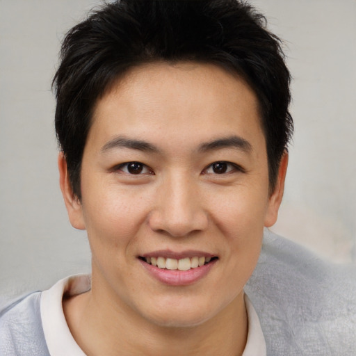 Joyful asian young-adult male with short  brown hair and brown eyes