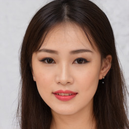 Joyful asian young-adult female with long  brown hair and brown eyes