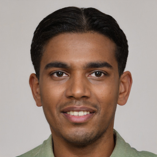Joyful black young-adult male with short  black hair and brown eyes