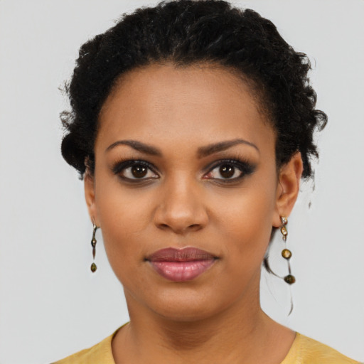 Joyful black young-adult female with short  black hair and brown eyes