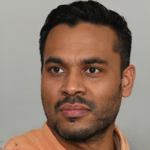 Neutral latino young-adult male with short  black hair and brown eyes
