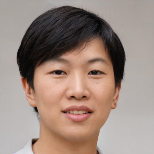 Joyful asian young-adult male with short  brown hair and brown eyes