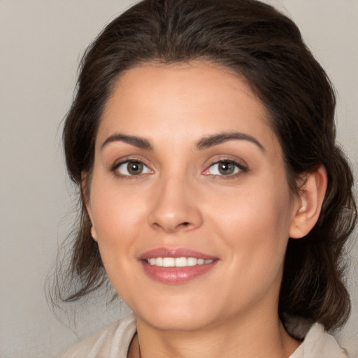 Joyful white young-adult female with medium  brown hair and brown eyes