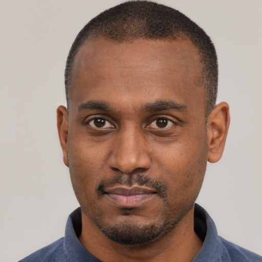 Neutral latino adult male with short  black hair and brown eyes