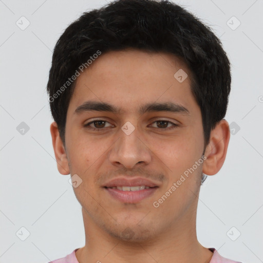 Joyful latino young-adult male with short  brown hair and brown eyes