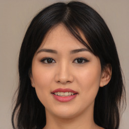 Joyful asian young-adult female with long  brown hair and brown eyes