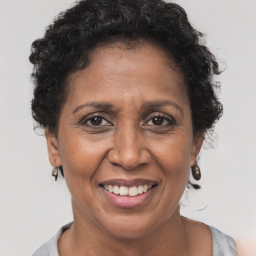 Joyful black adult female with short  brown hair and brown eyes