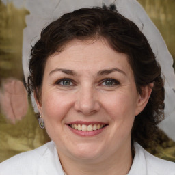 Joyful white adult female with medium  brown hair and brown eyes