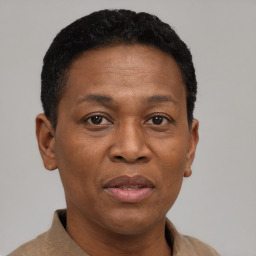 Joyful black adult female with short  brown hair and brown eyes