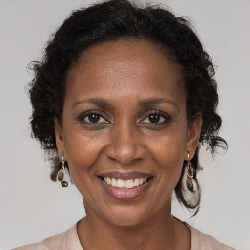 Joyful black adult female with medium  brown hair and brown eyes